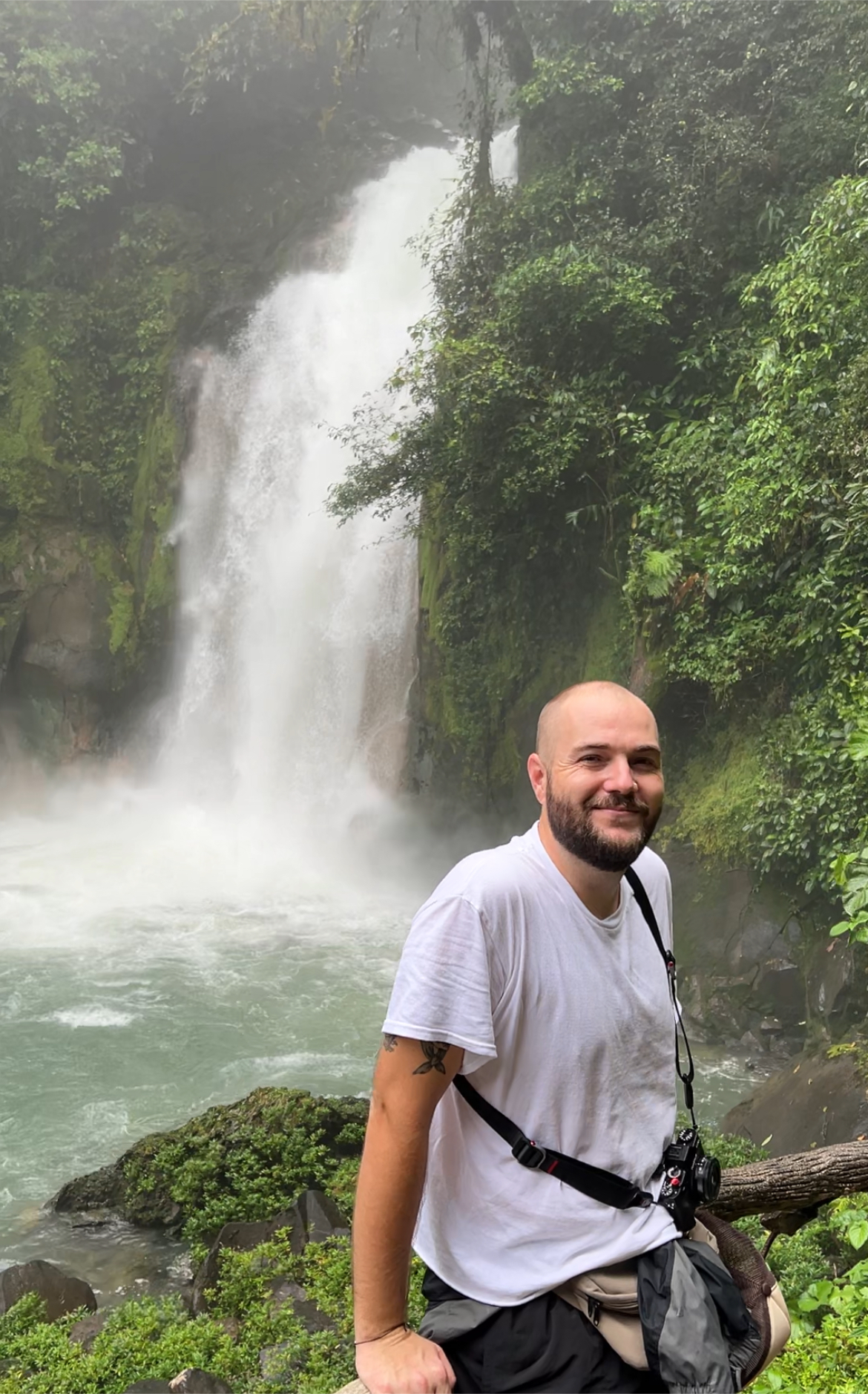 Me sitting by a waterfall in Costa Rica